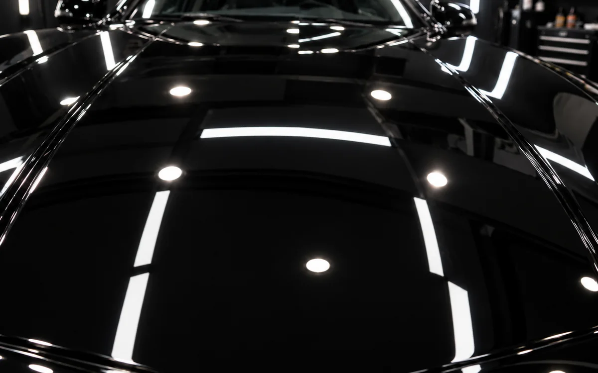 Black bonnet after polishing, reflections sharp and free of swirl marks